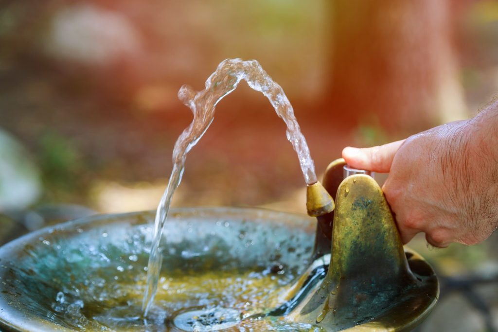 Drinking water running from an water tap a water fountain in park